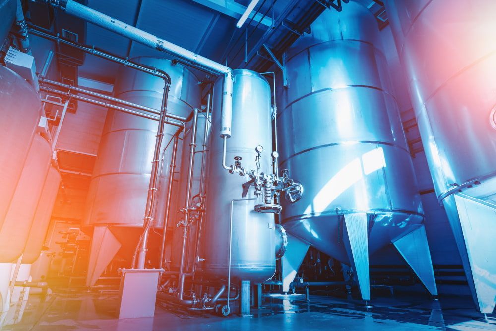 A Factory With a Lot of Stainless Steel Tanks and Pipes — Todd Hayes Refrigeration & Air Conditioning Pty Ltd in Kyogle, NSW