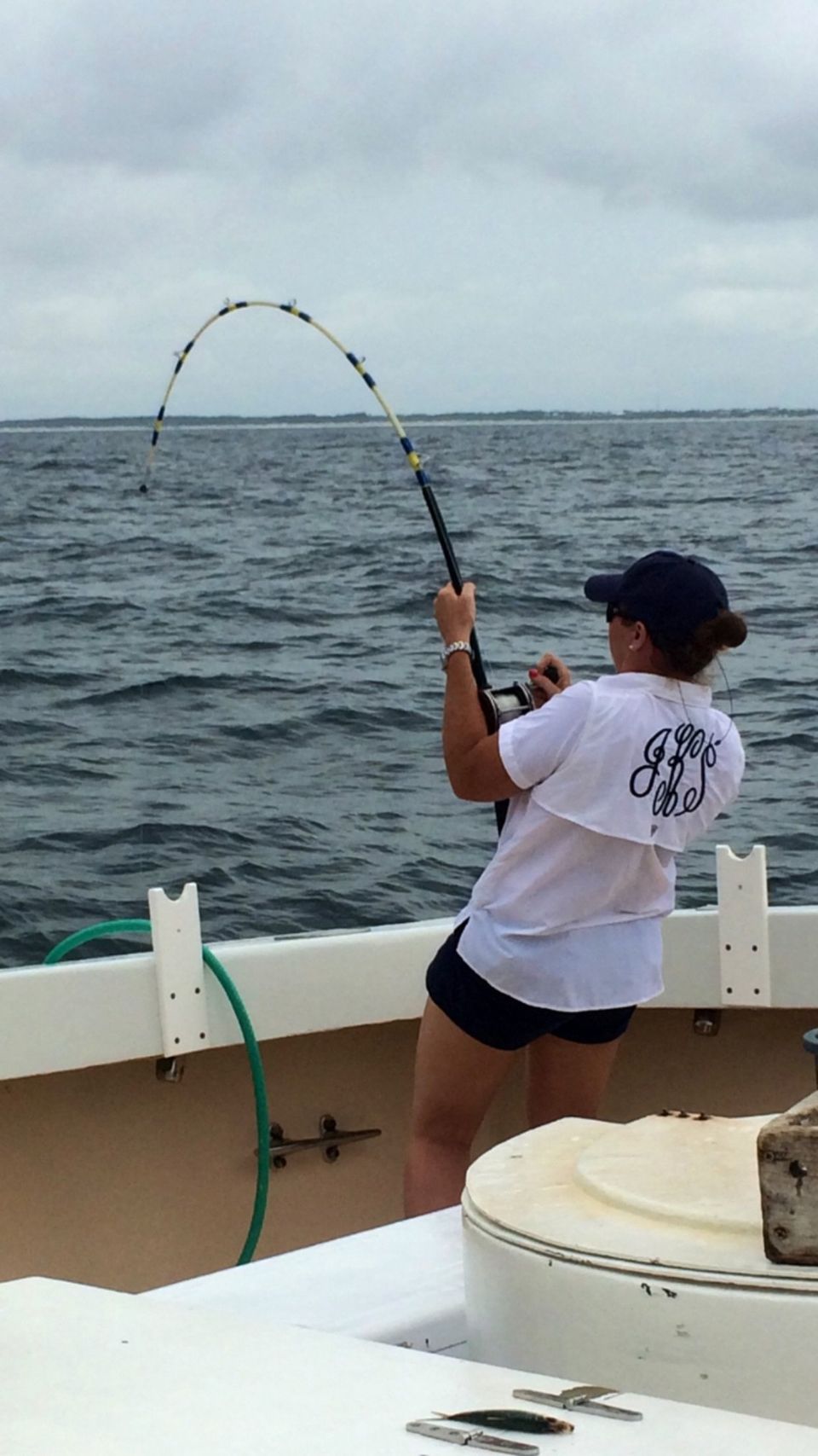 Fishing Destin, FL | Destin Harbor | Charter Boat Relentless | www.charterboatrelentless.com | A Luxury Charter Boat at Everyday Rates | 65' x 20' | A woman is fishing in the ocean on a boat