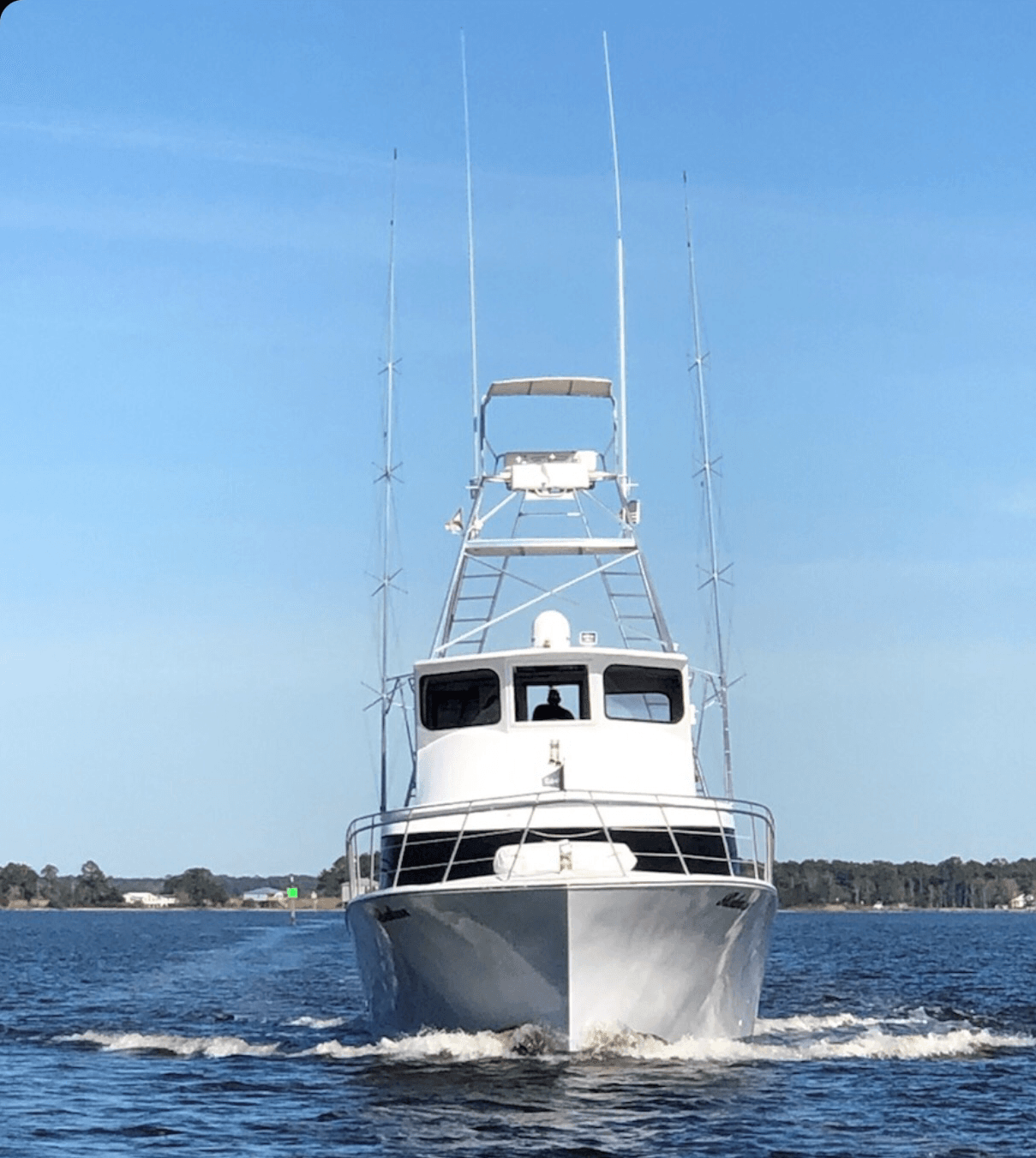 AFishing Destin, FL | Destin Harbor | Charter Boat Relentless | www.charterboatrelentless.com | A Luxury Charter Boat at Everyday Rates | 65' x 20' | large white boat is floating on top of a body of water.