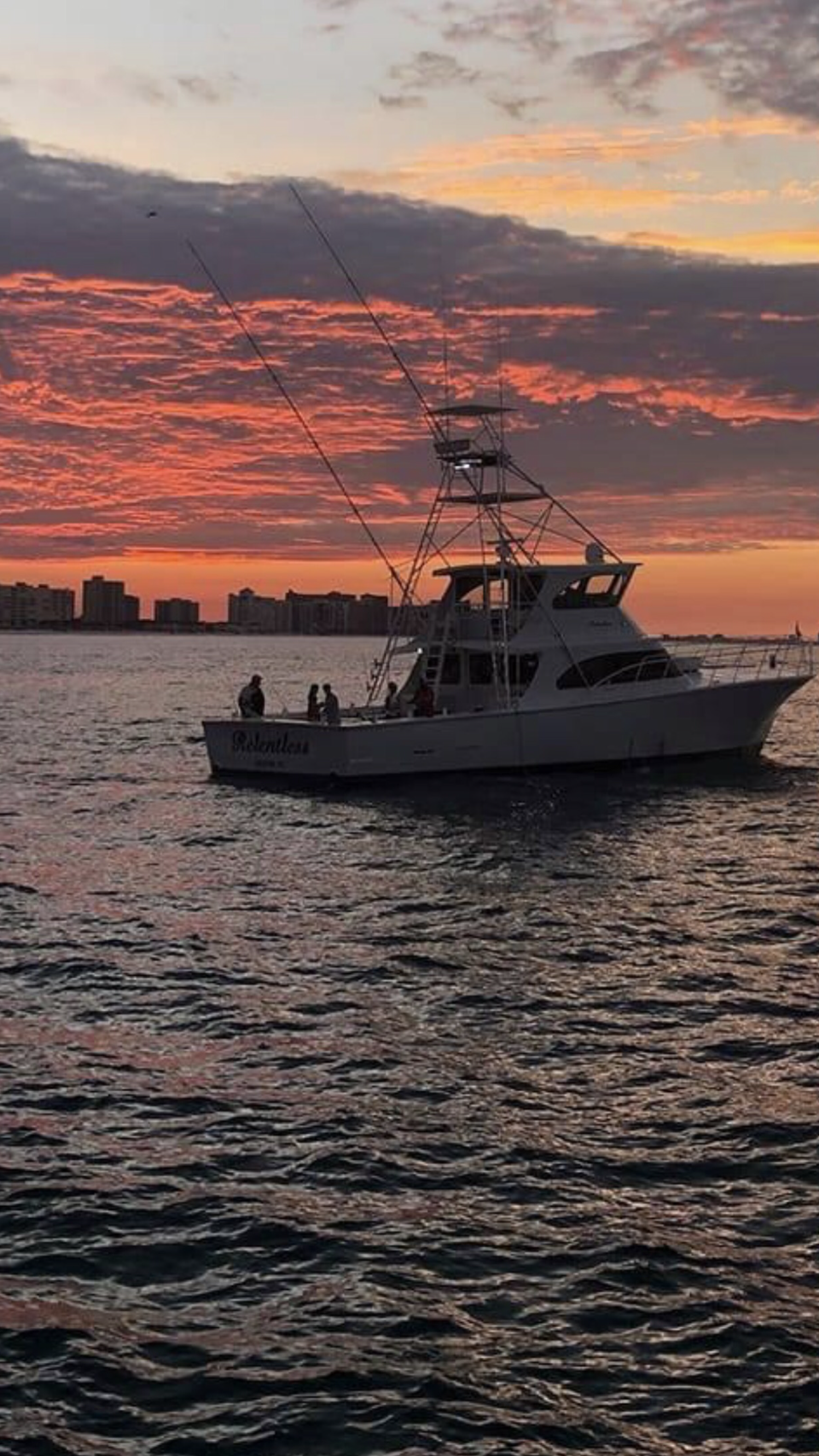 Fishing Destin, FL | Destin Harbor | Charter Boat Relentless | www.charterboatrelentless.com | A Luxury Charter Boat at Everyday Rates | 65' x 20' | Charter Boat Relentless is floating in Destin Harbor at sunset.