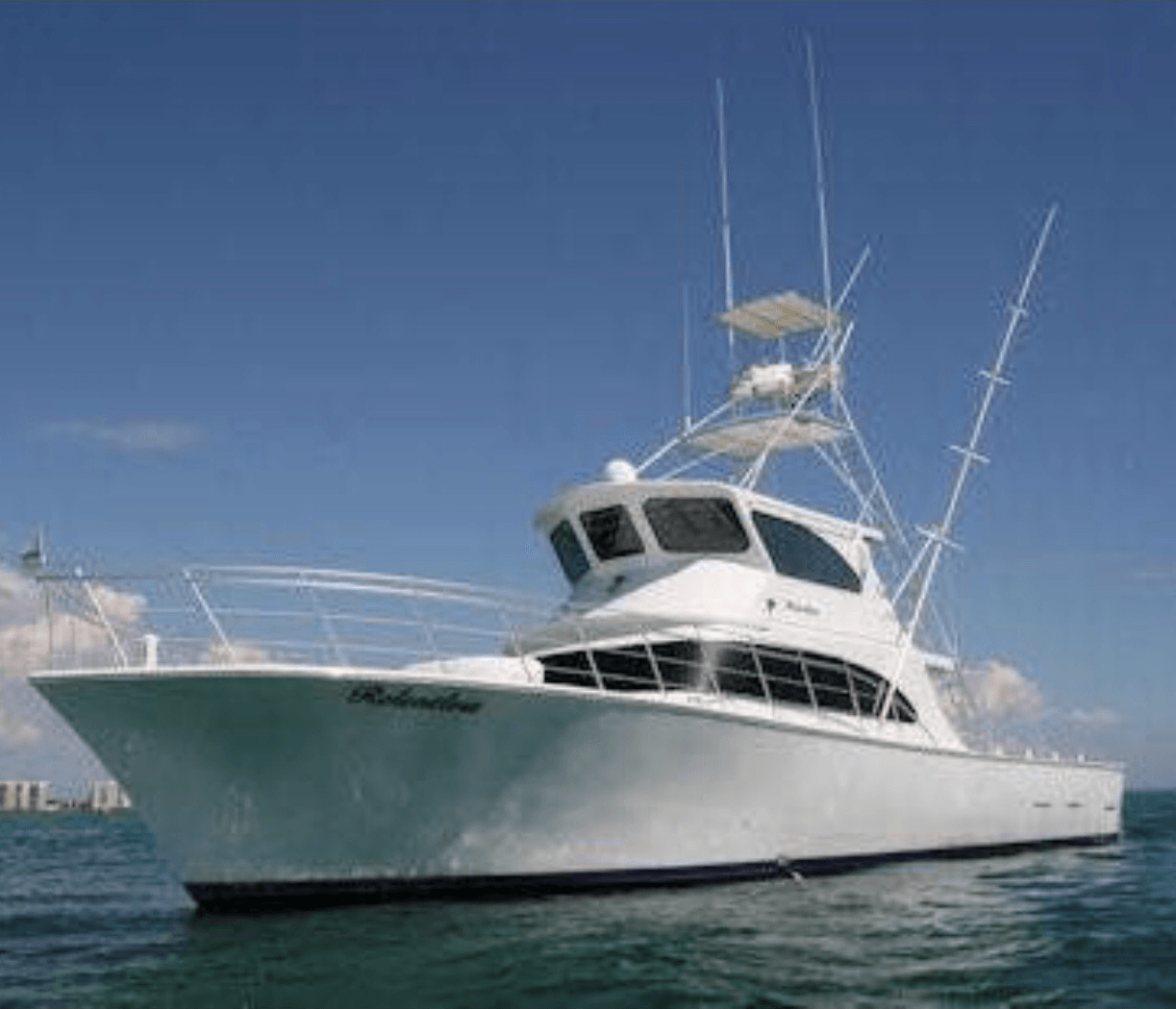 Fishing Destin, FL | Destin Harbor | Charter Boat Relentless | www.charterboatrelentless.com | A Luxury Charter Boat at Everyday Rates | 65' x 20' | A large white Charter Boat Relentless is floating off the coast of Destin, FL.