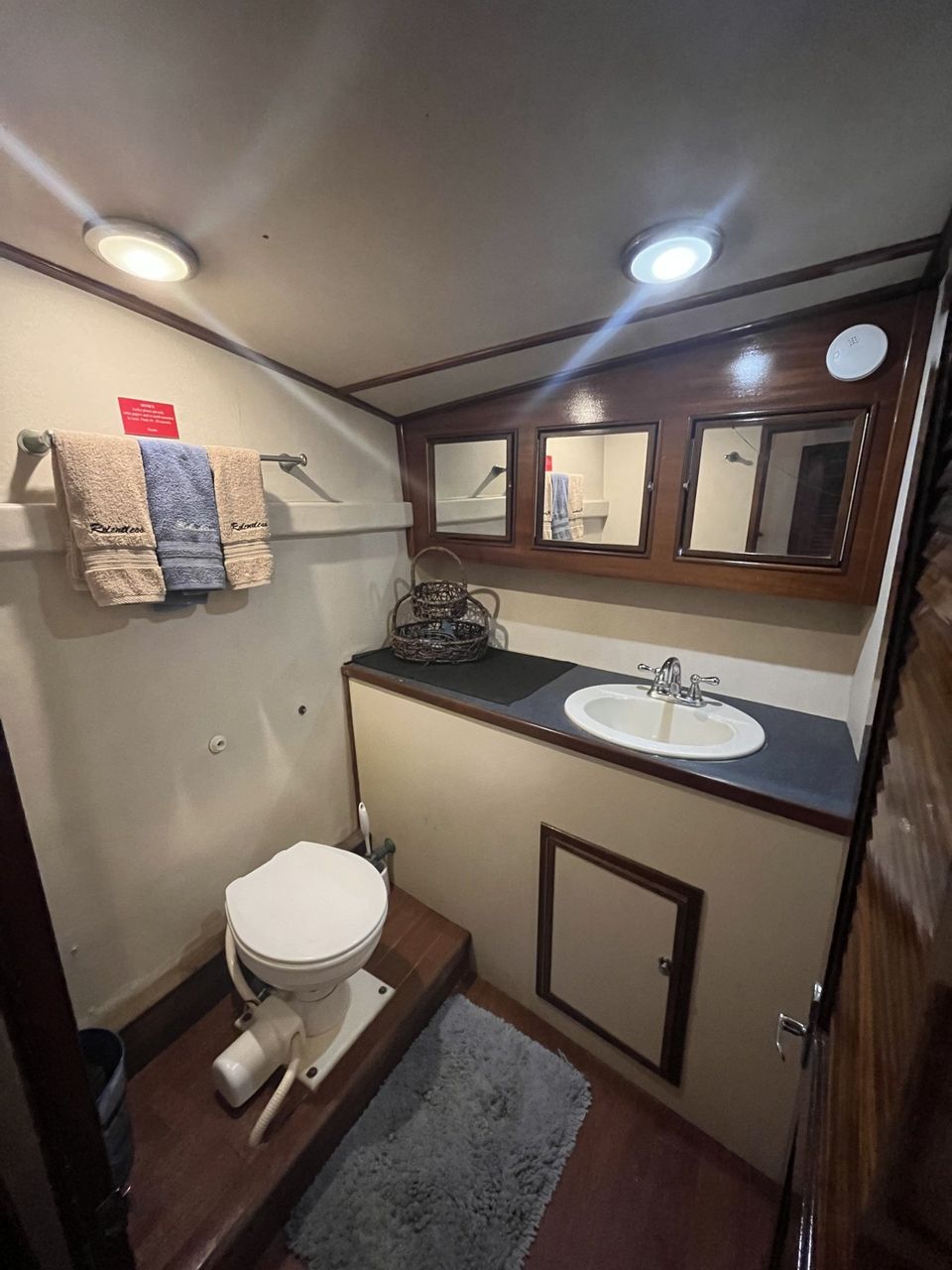 Fishing Destin, FL | Destin Harbor | Charter Boat Relentless | www.charterboatrelentless.com | A Luxury Charter Boat at Everyday Rates | 65' x 20' | A bathroom with a toilet , sink and mirrors.