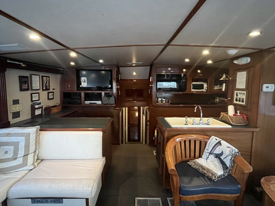 Fishing Destin, FL | Destin Harbor | Charter Boat Relentless | www.charterboatrelentless.com | A Luxury Charter Boat at Everyday Rates | 65' x 20' | A living room on a boat with a couch and chairs