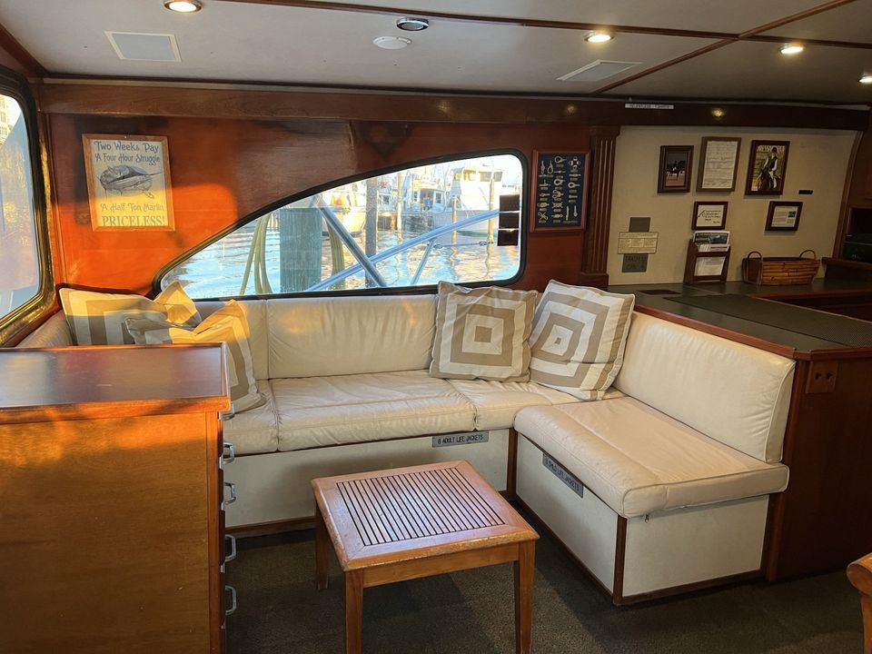 Fishing Destin, FL | Destin Harbor | Charter Boat Relentless | www.charterboatrelentless.com | A Luxury Charter Boat at Everyday Rates | 65' x 20' | A living room on a boat with a couch and a table