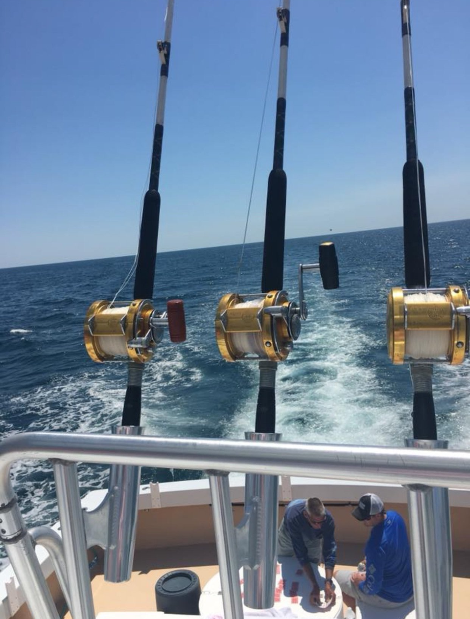 TFishing Destin, FL | Destin Harbor | Charter Boat Relentless | www.charterboatrelentless.com | A Luxury Charter Boat at Everyday Rates | 65' x 20' | hree fishing rods are on a boat in the ocean