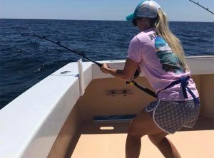 Fishing Destin, FL | Destin Harbor | Charter Boat Relentless | www.charterboatrelentless.com | A Luxury Charter Boat at Everyday Rates | 65' x 20' | A woman is fighting a fish in the Gulf of Mexico.