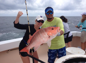 Fishing Destin, FL | Destin Harbor | Charter Boat Relentless | www.charterboatrelentless.com | A Luxury Charter Boat at Everyday Rates | 65' x 20' | A man and woman holding a large red snapper on the Relentless.