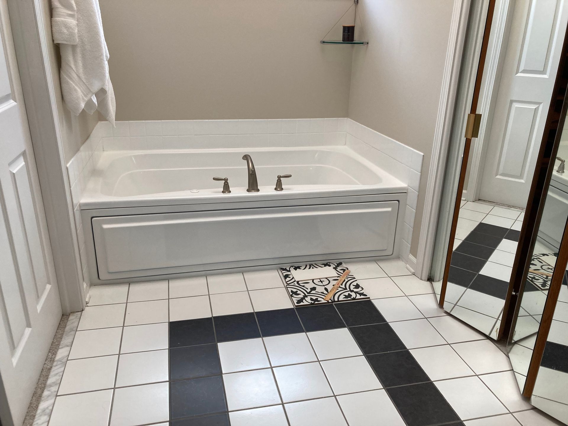 Bathroom with a white tiled floor, a built-in tub, and a walk-in shower.