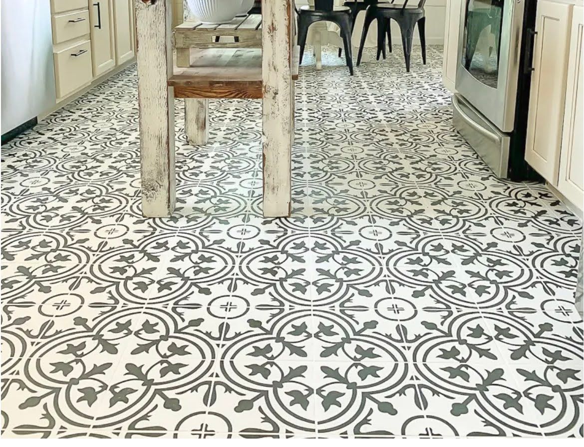 Patterned tile floor in a kitchen with chairs and appliances along the sides
