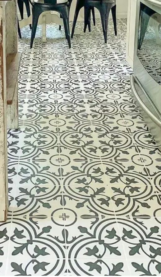 Patterned tiled floor with ornate green and cream designs beneath chairs and tables