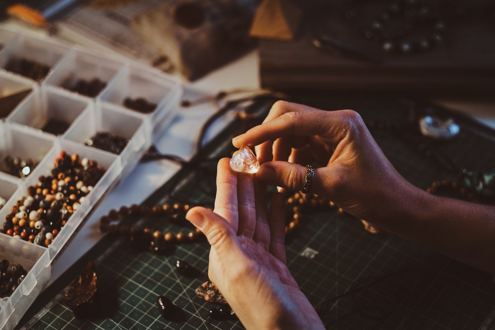 a person is holding a piece of crystal in their hand .