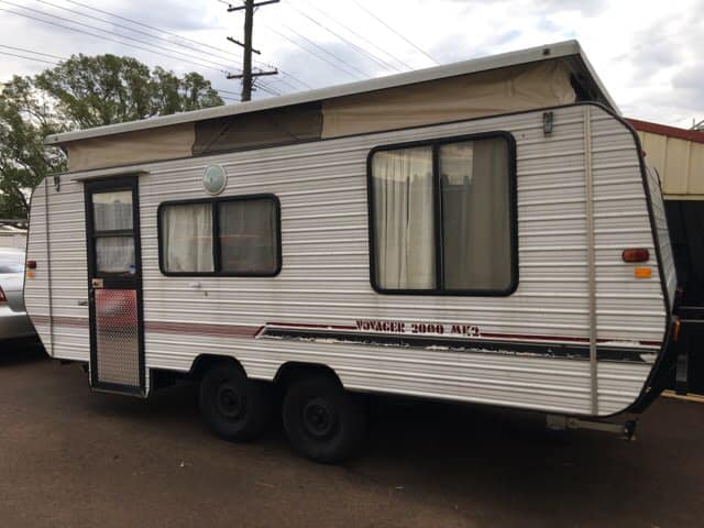 White Pop-top Caravan With Black Wheels — Andy's Caravan Repairs in Harristown, QLD
