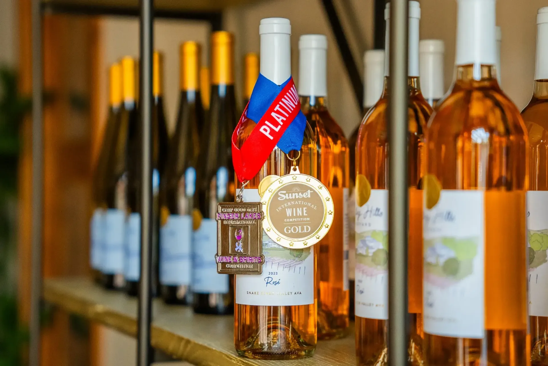 Wine bottles on a shelf, one with a