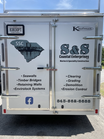 Commercial truck rear with S&S Coastal Enterprises signs and service list on white doors