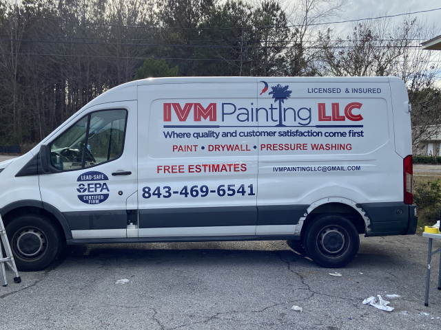 IVM Painting LLC van parked roadside with company logo, phone number, and service list on the side