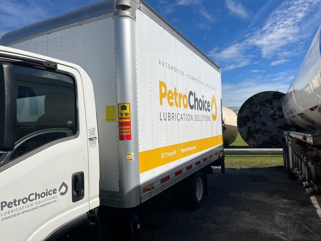 PetroChoice box truck parked outdoors under a blue sky