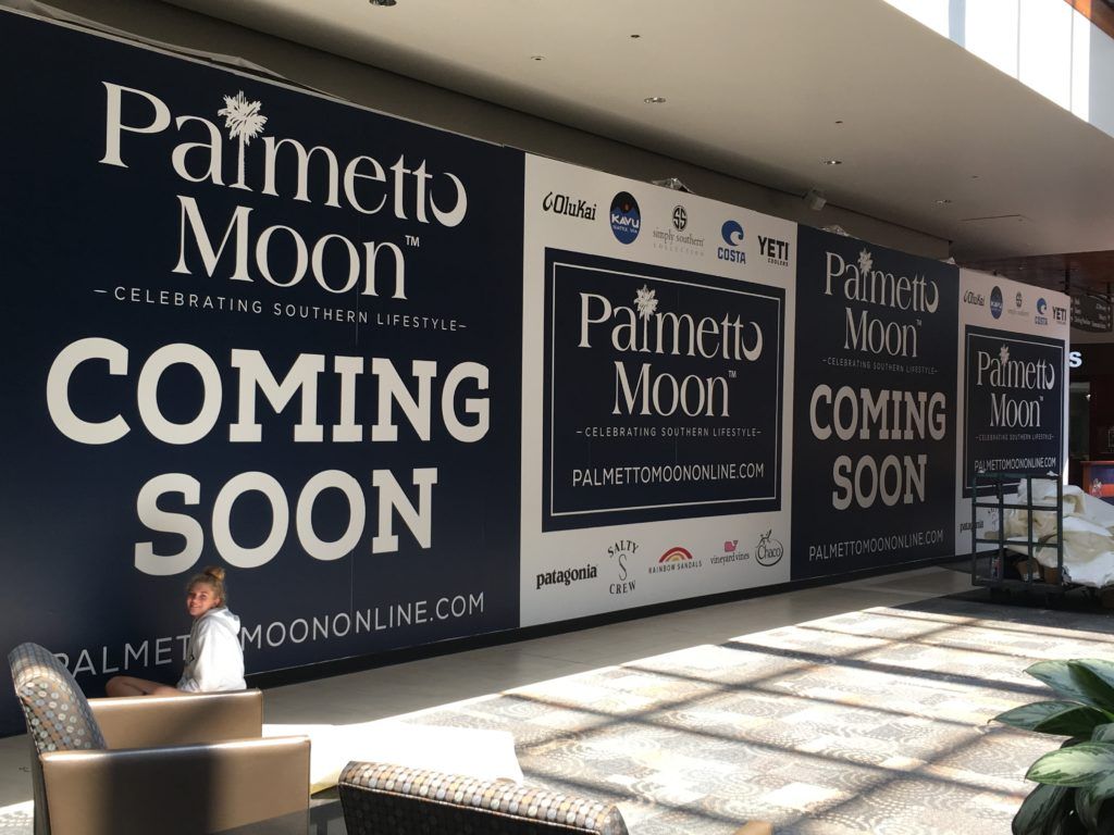 Storefront signage for Palmetto Moon with large “COMING SOON” banners in a mall corridor