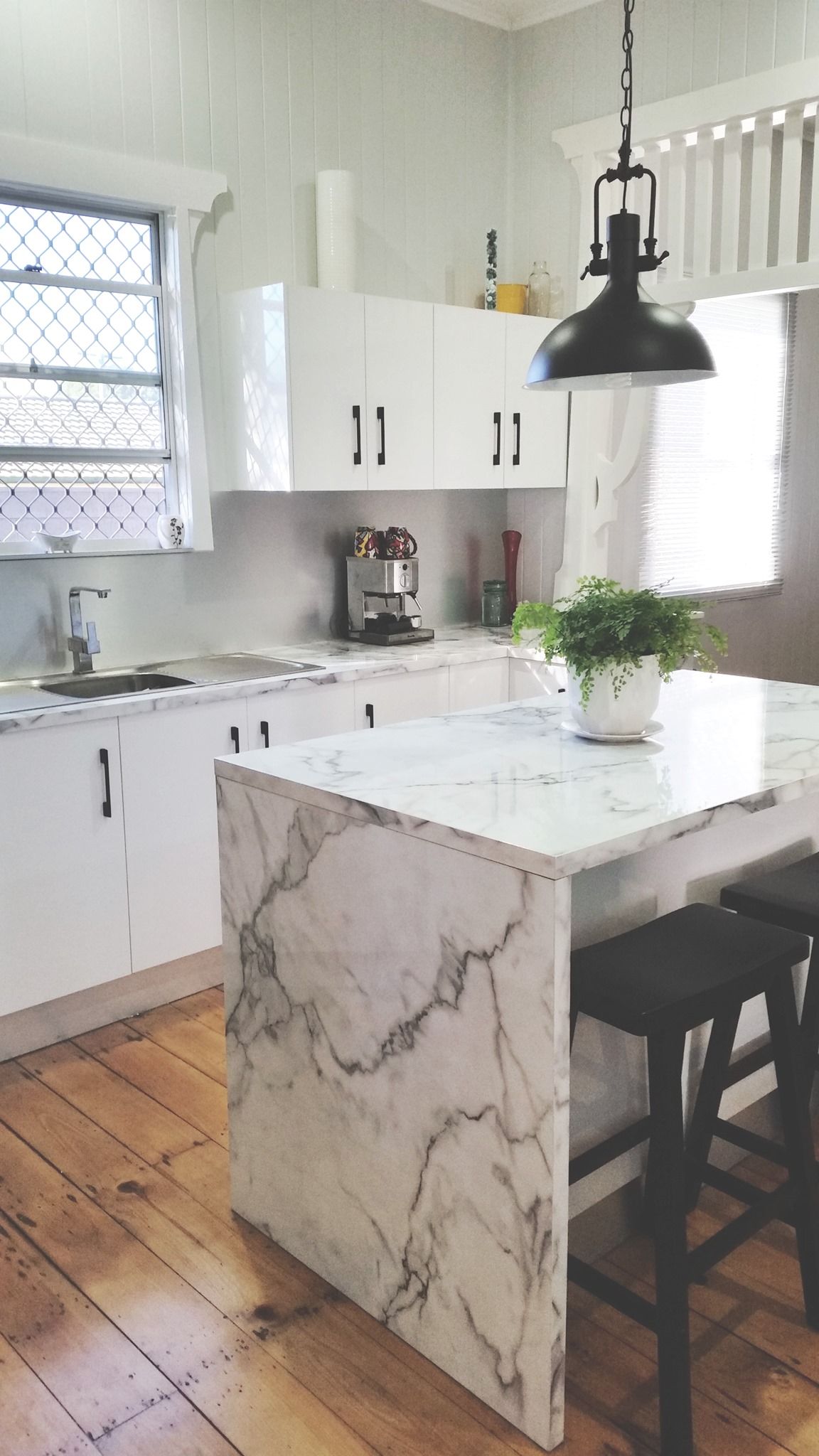 White Kitchen With Marble Island, Cabinets, and Wooden Floors — Payton Kitchens in Gatton, QLD
