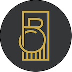 A black and gold logo in a circle on a white background.