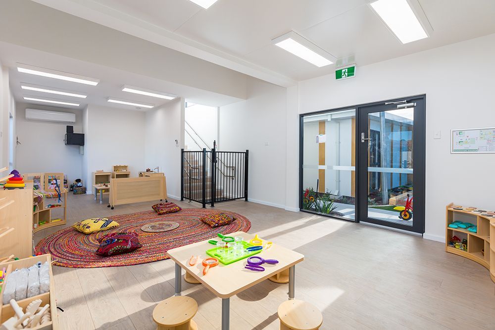 Thornlie playroom with red rug. Brightly lit.