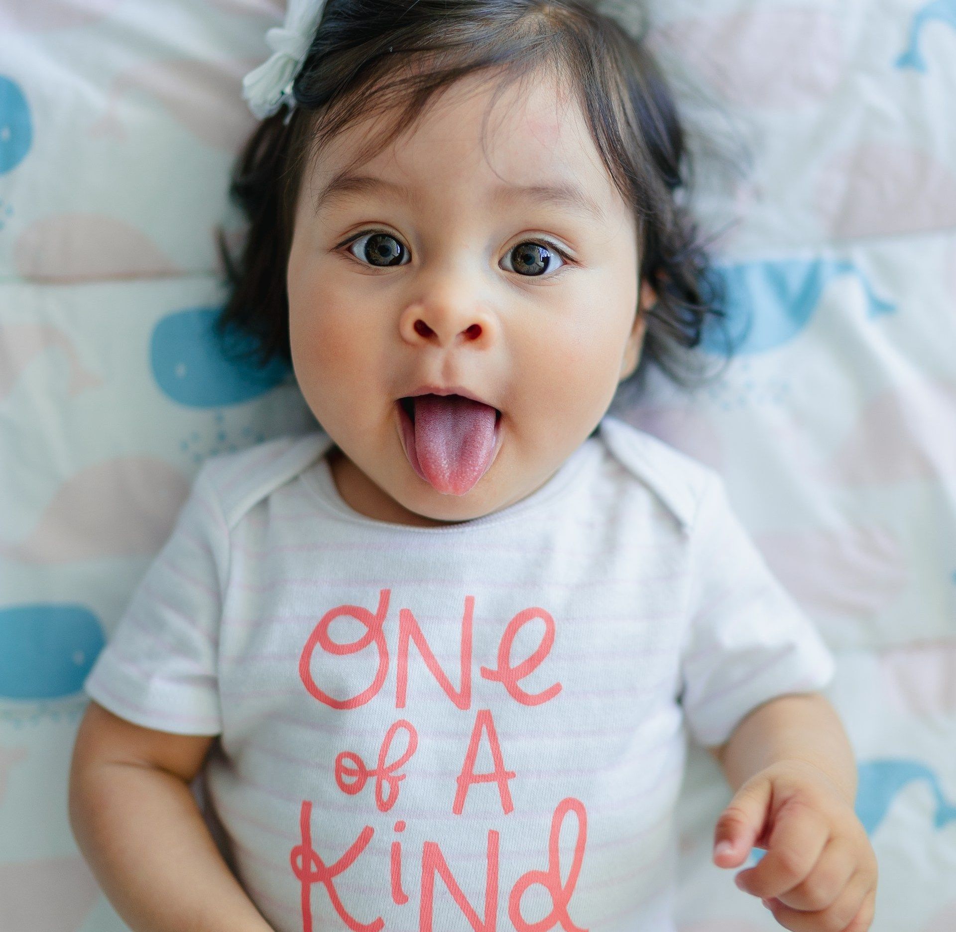 A baby is making a funny face at Thornlie Early Learning Centre.