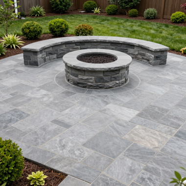 Stone patio with a curved bench and circular fire pit in a landscaped backyard
