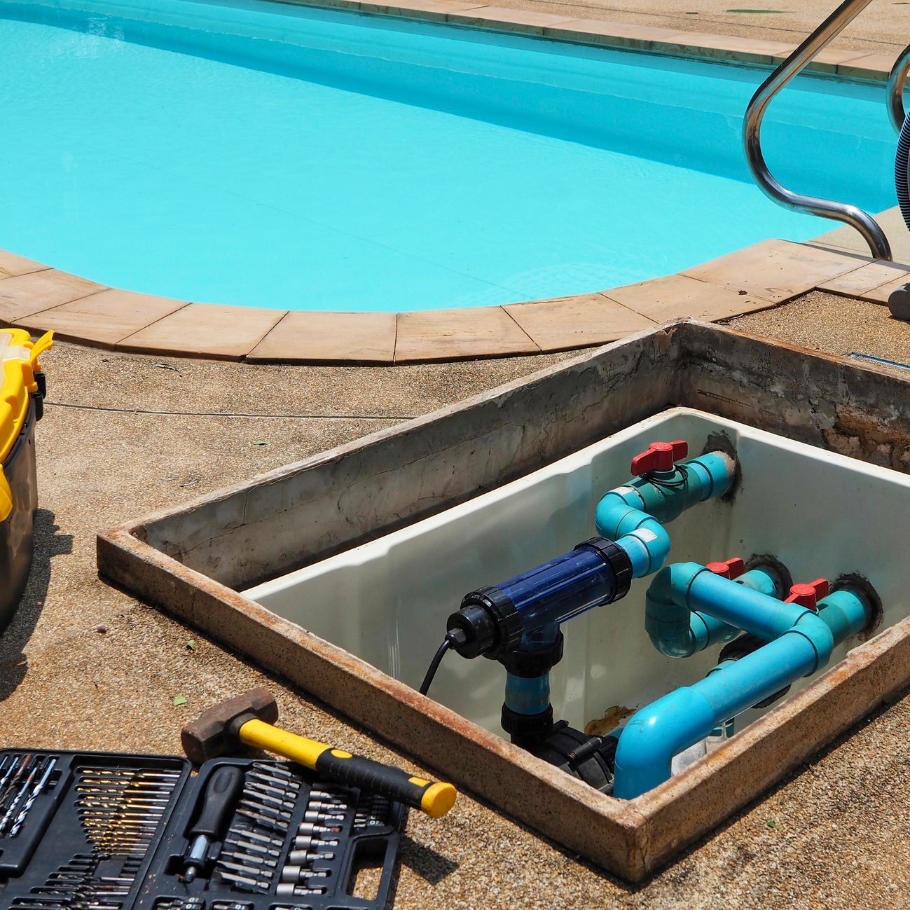 A swimming pool with a box of tools in front of it A swimming pool with a box of tools in front of it