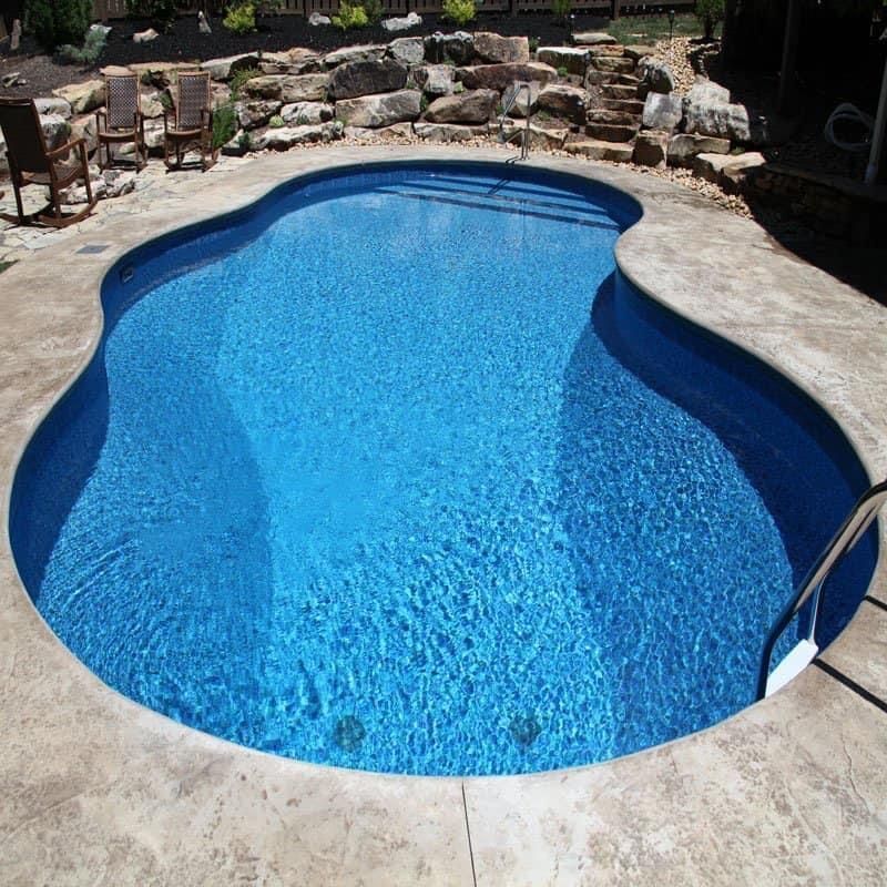 A boy is jumping into a swimming pool. A boy is jumping into a swimming pool.