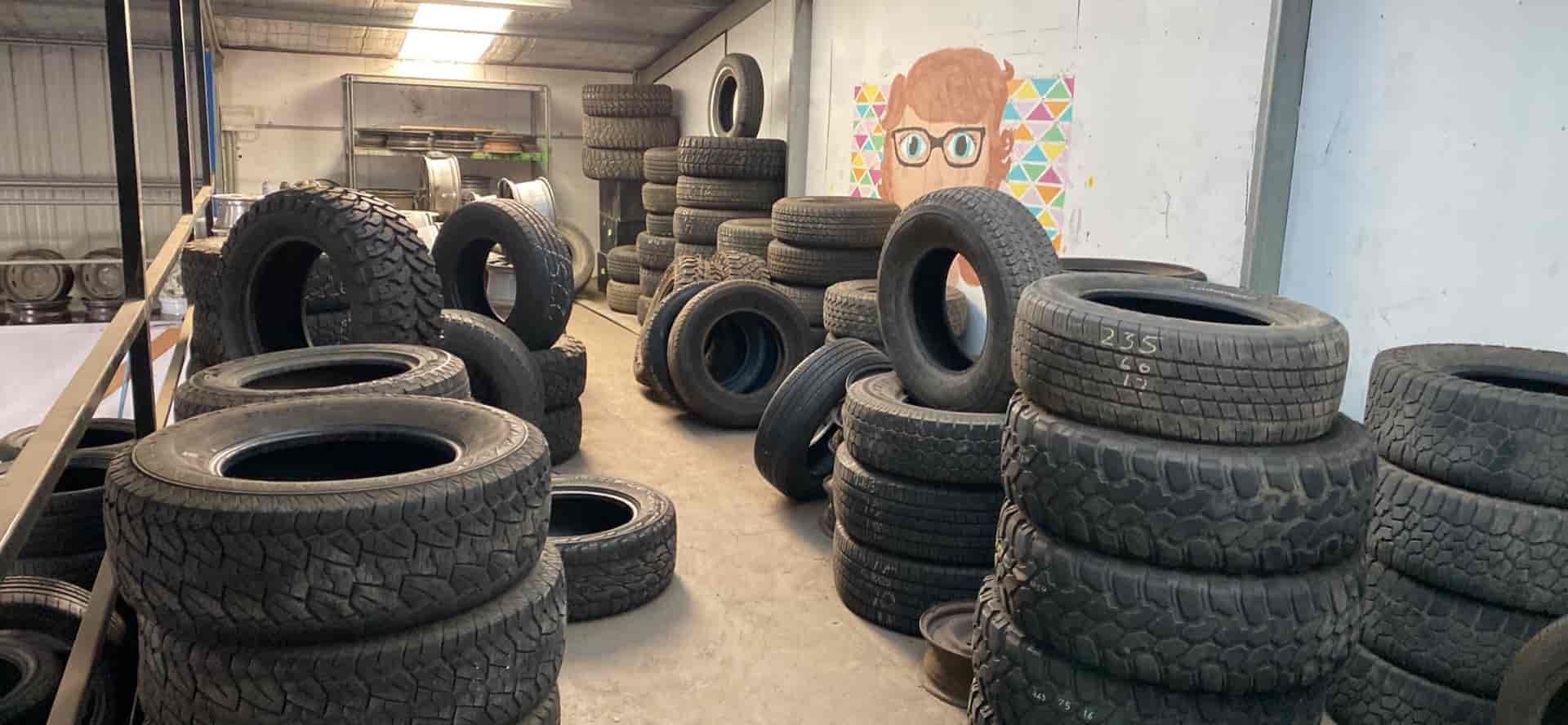A Warehouse Filled With Lots of Tyres Stacked on Top of Each Other — ARB Budget Tyres in Delacombe, VIC