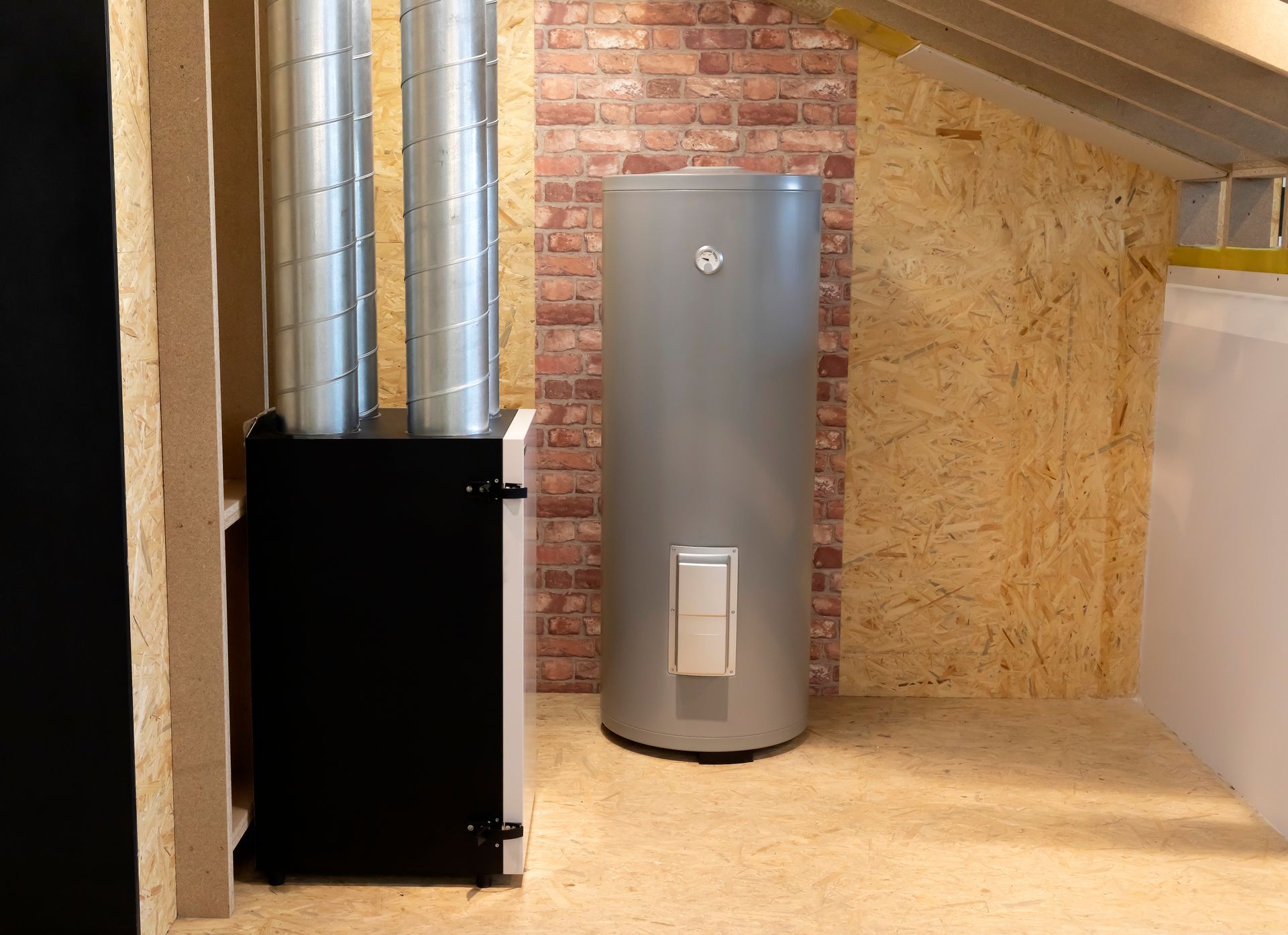 Hand turning a white thermostat dial on a wall-mounted water heater control panel.