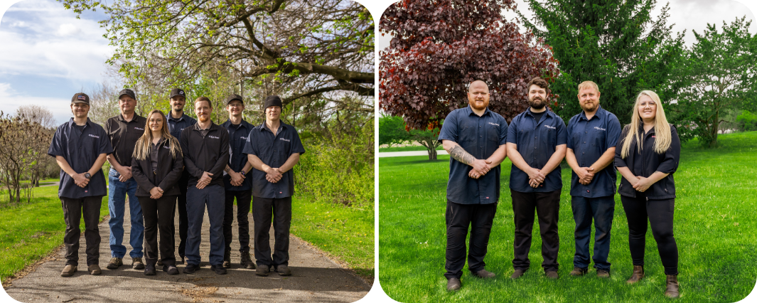 Seven people in dark clothing standing together in a green orchard under trees | Bob's Main Street Auto