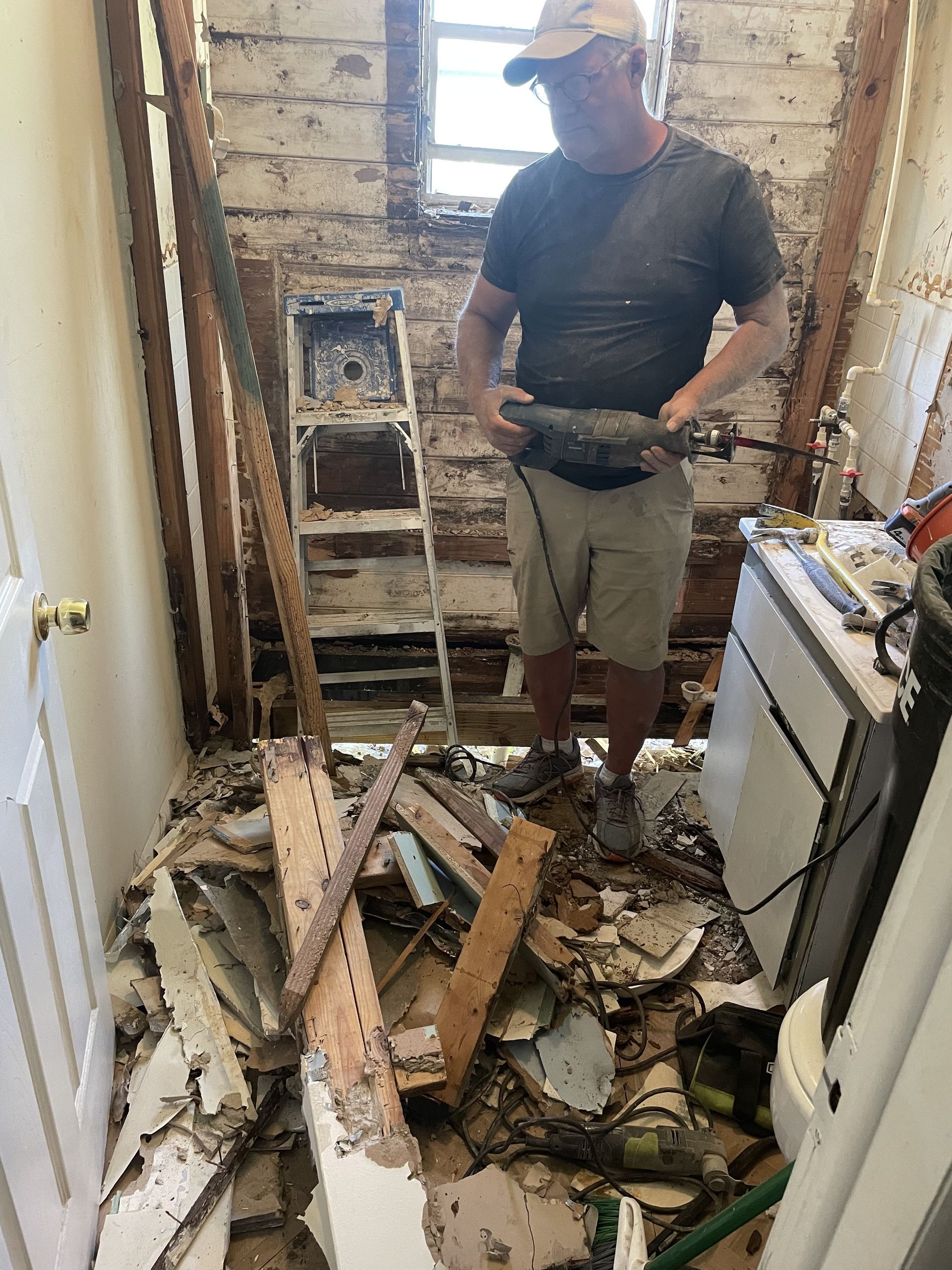 debris on the floor of a demolished bathroom