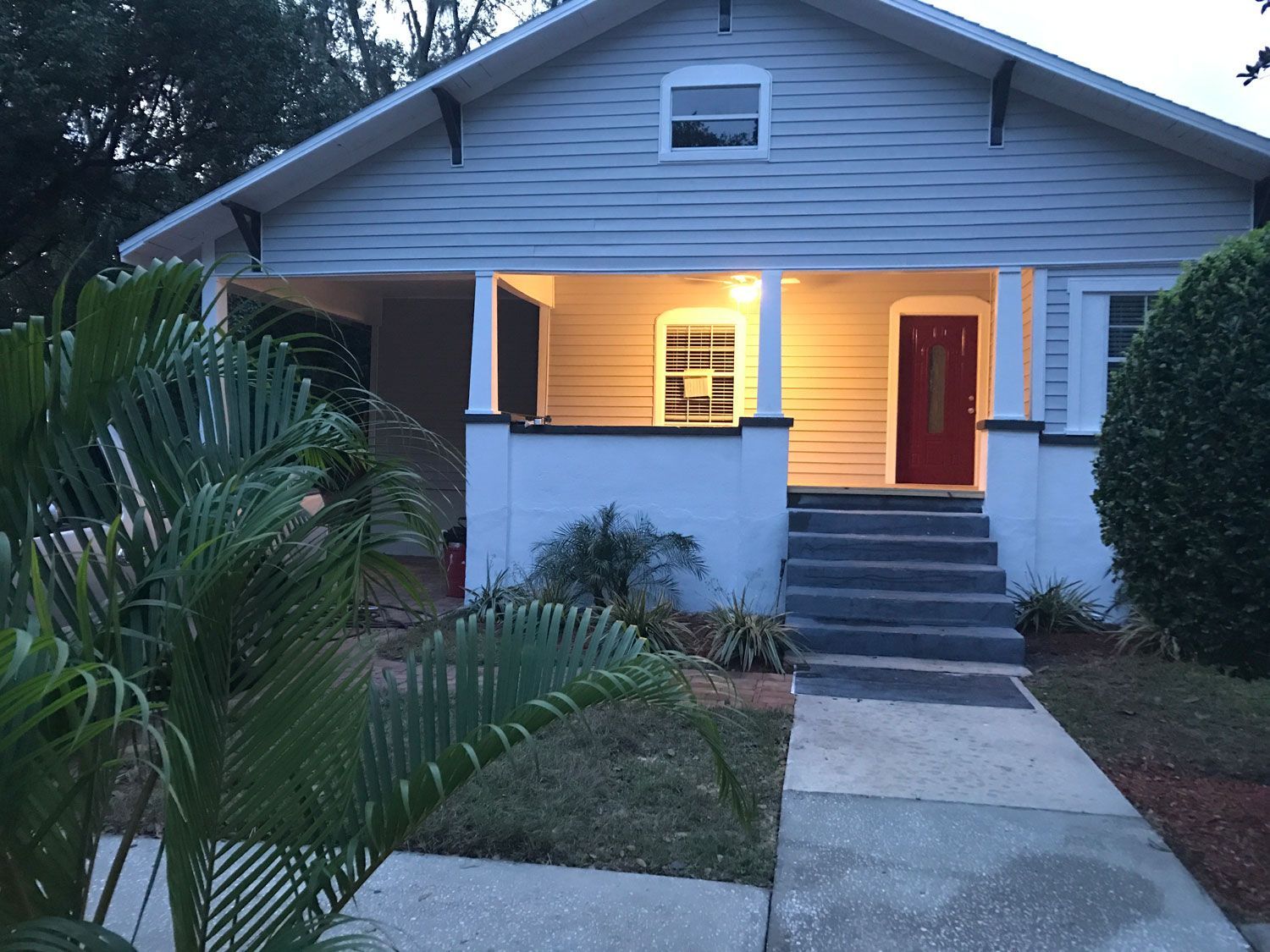 exterior view of a newly painted house with light on the porch