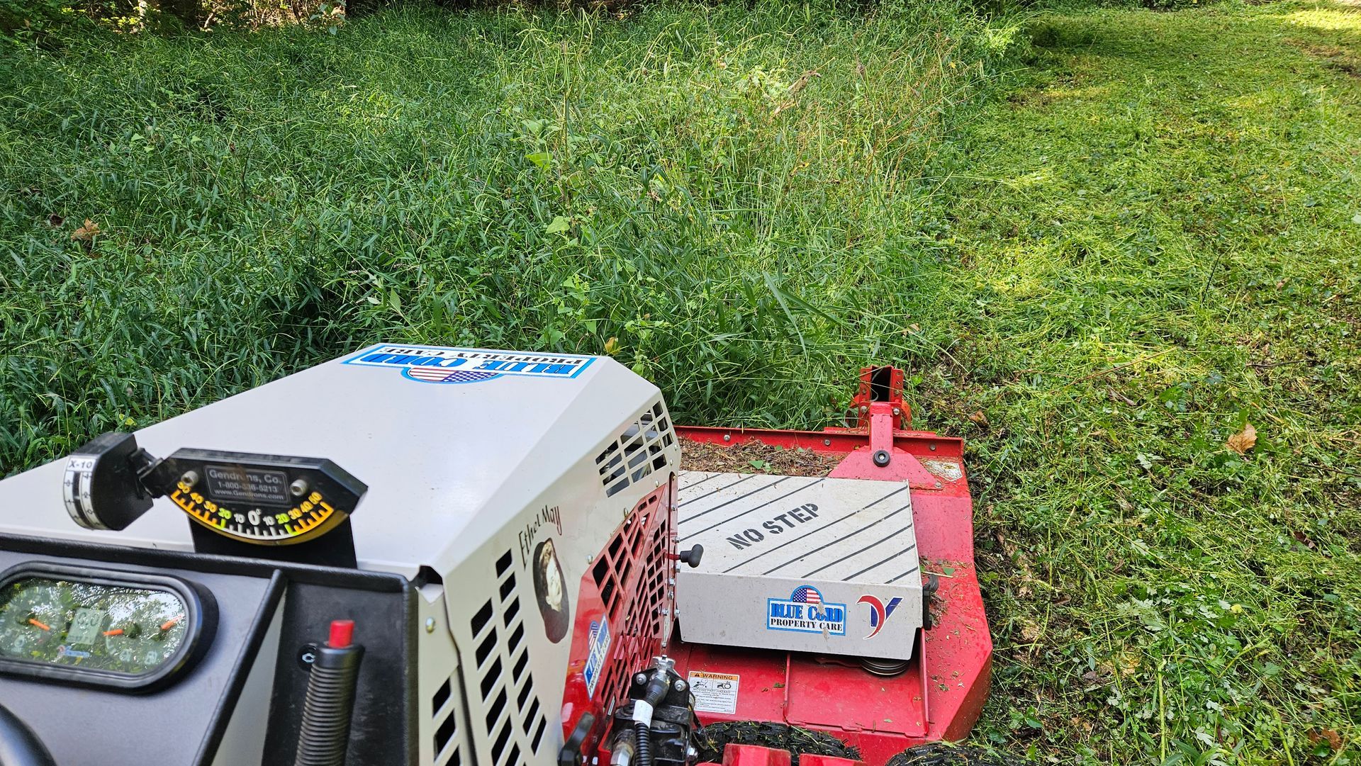 A tractor is cutting grass in a field.