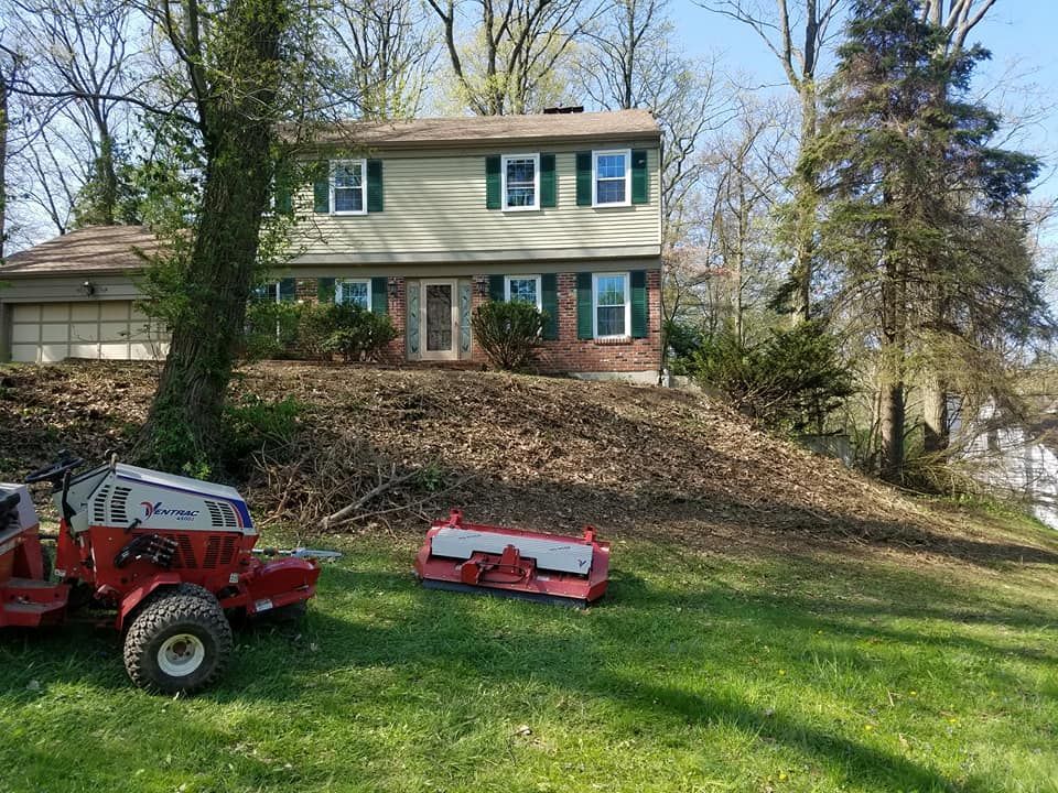 A lawn mower is parked in front of a house.