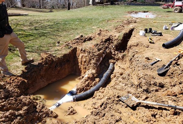 A person is digging a hole in the dirt
