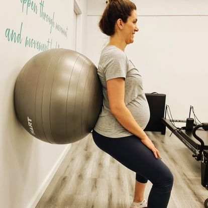 pregnant womman working with a yoga ball