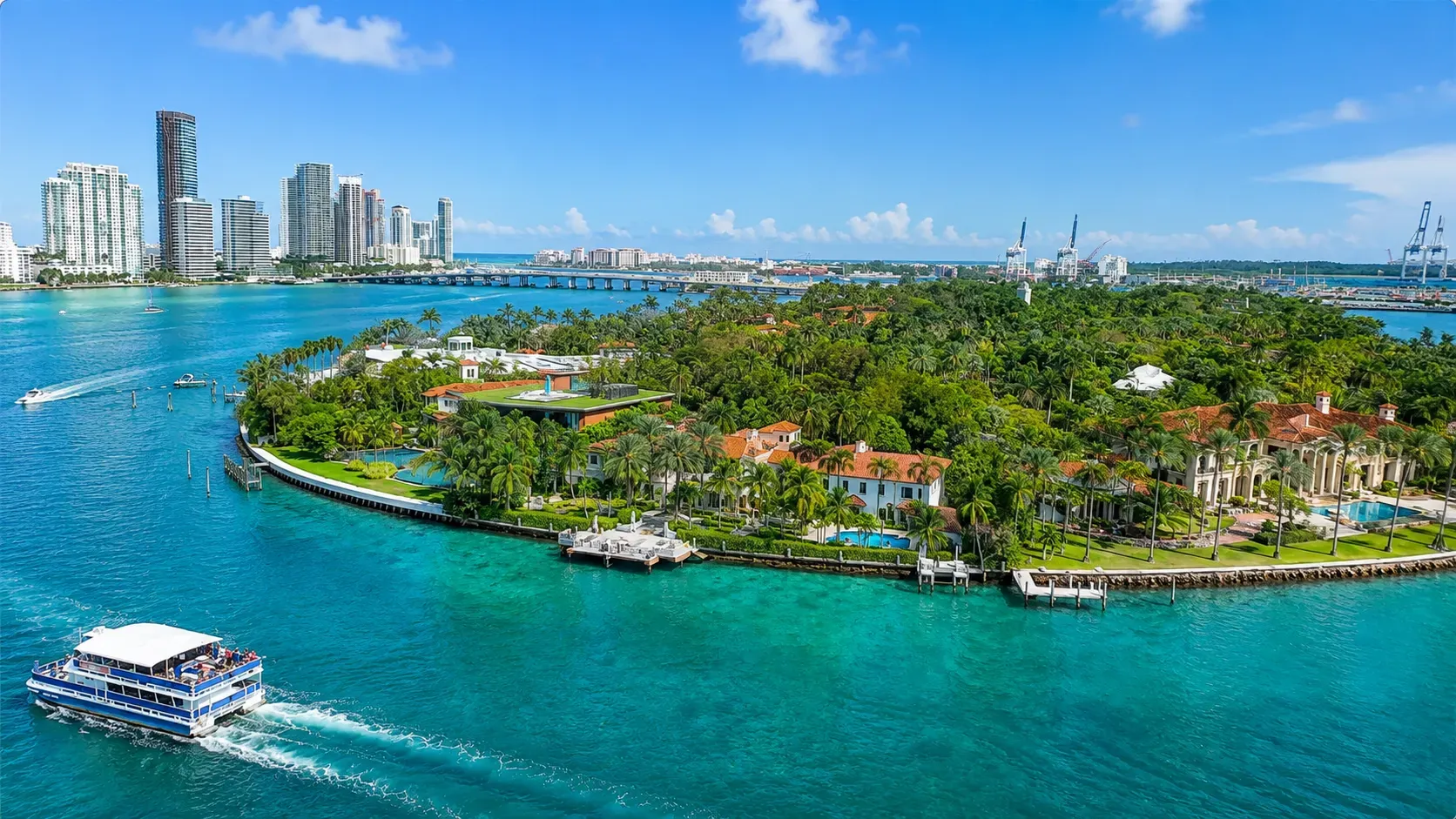 Star Island Miami waterfront mansions and sightseeing boat on Biscayne Bay
