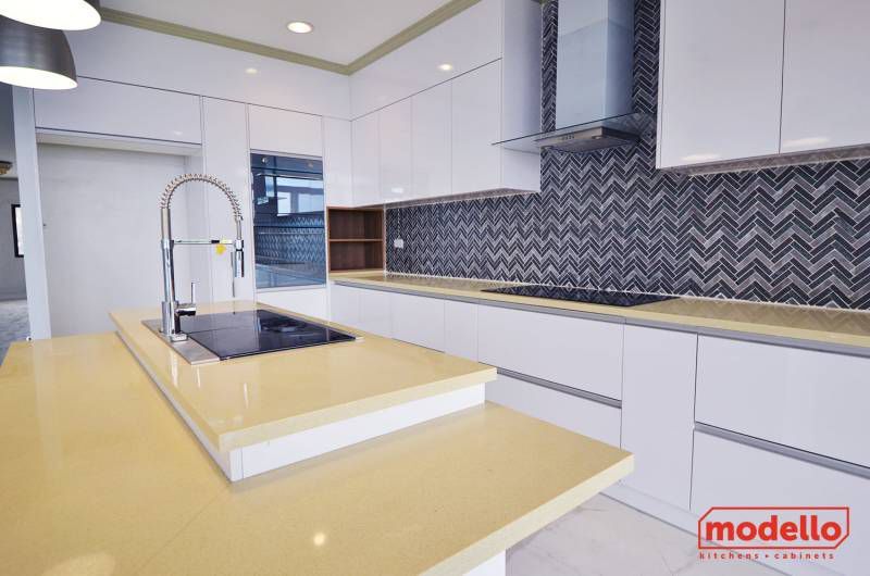 A Kitchen With White Cabinets, A Sink, And A Stove — ModulPlus in Hervey Bay, QLD