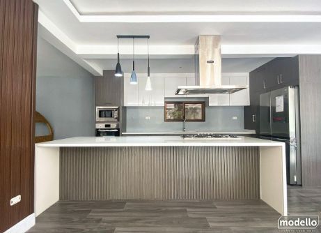A Kitchen With a Large Island and a Stove Top Oven — ModulPlus in Hervey Bay, QLD