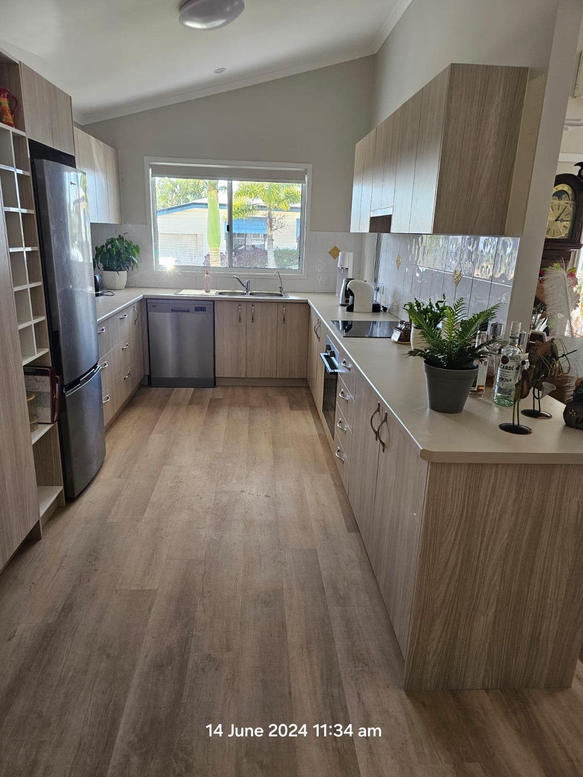 U-shaped Kitchen With Light Wood Cabinetry, Stainless Steel Appliances, and a Window Above the Sink β ModulPlus in Burrum Heads, QLD