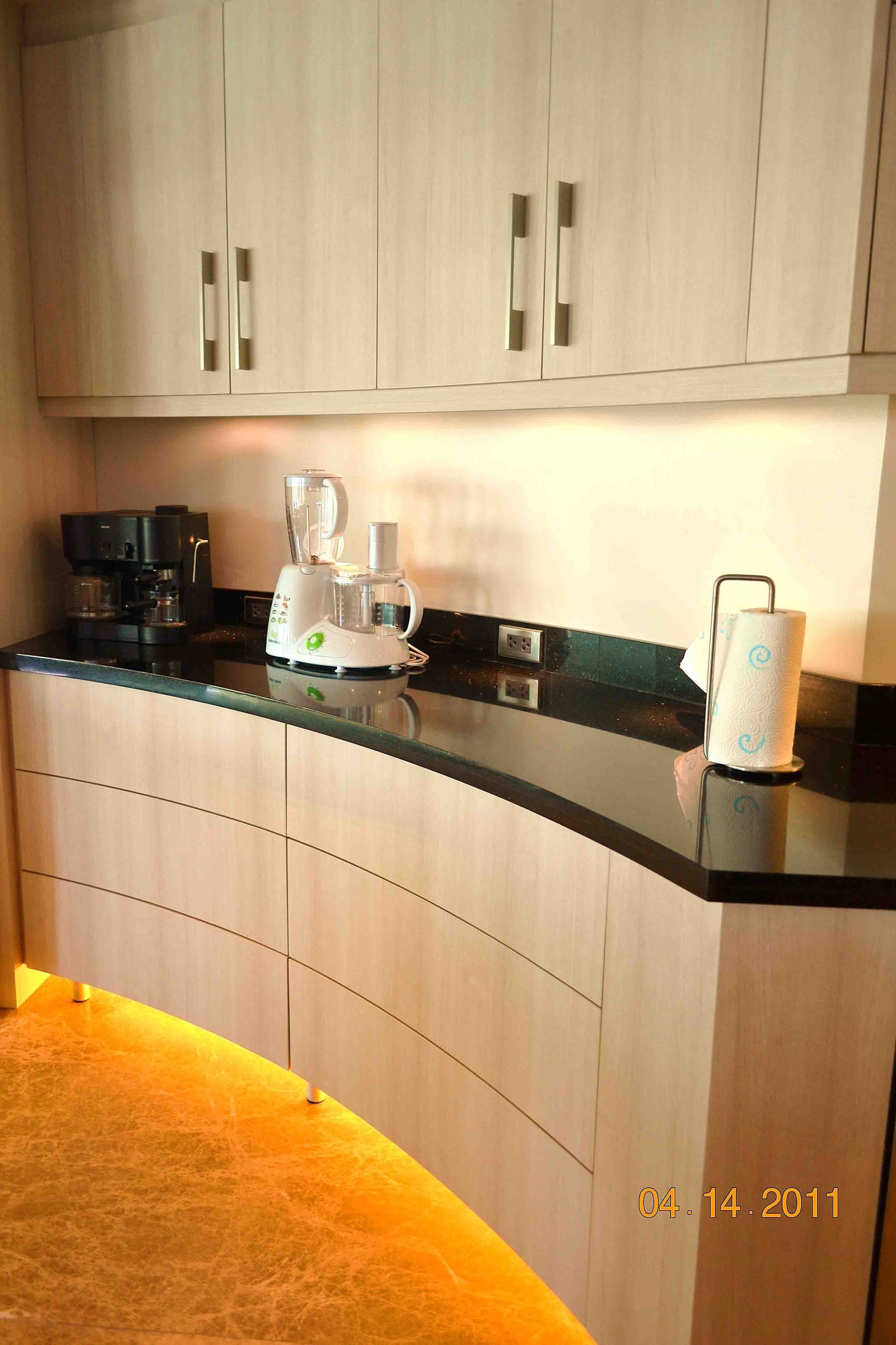 Curved Kitchen Counter With Cabinets Above and Below, Appliances on the Countertop, and Under-cabinet Lighting β ModulPlus in Maryborough, QLD