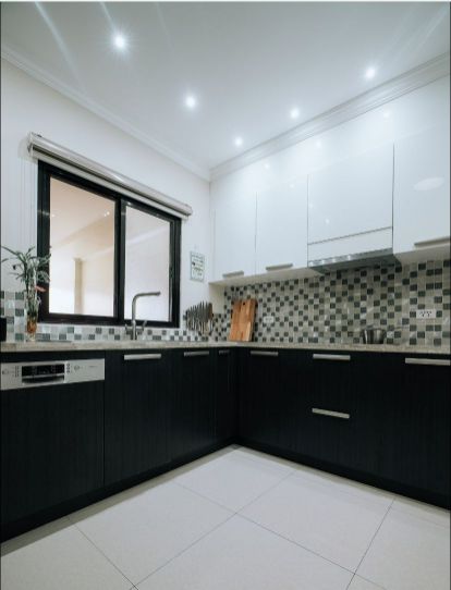 A Kitchen With Black Cabinets and White Counter Tops — ModulPlus in Hervey Bay, QLD