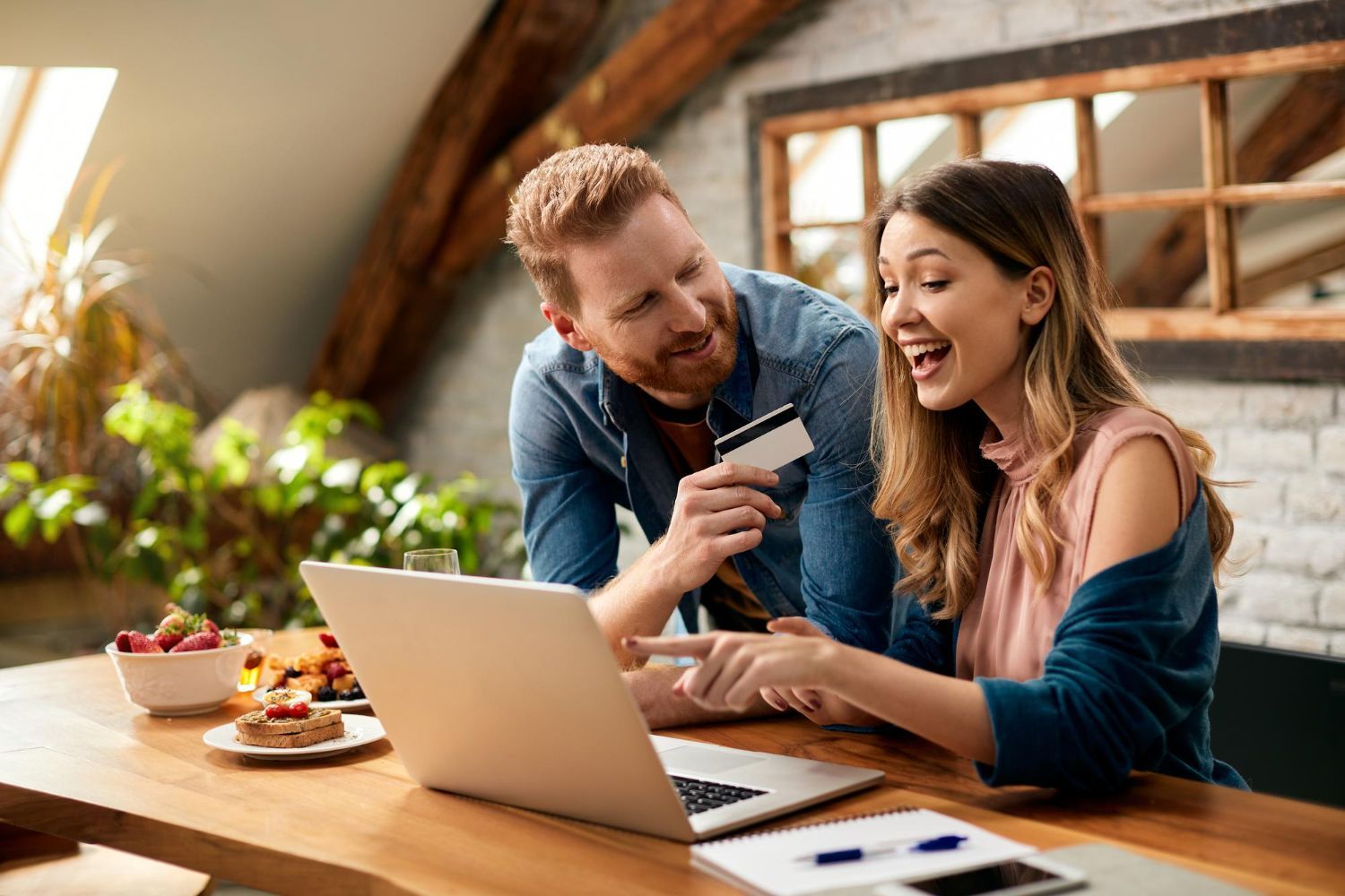 Small business owners reviewing financial plans on laptop