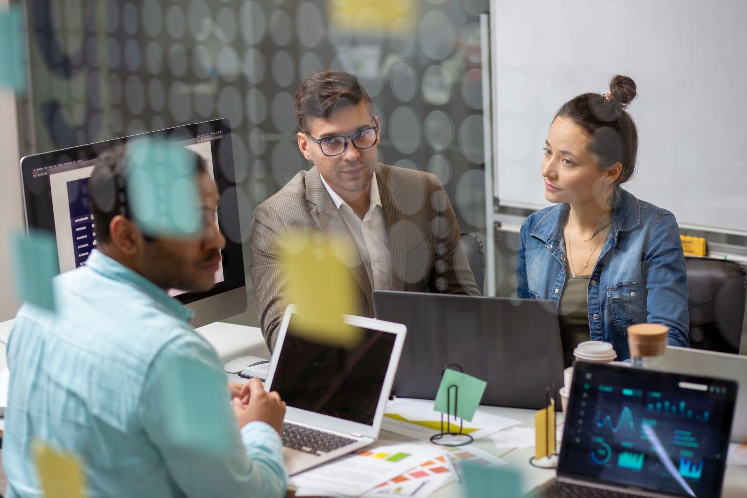 Small business team collaborating on project in modern office