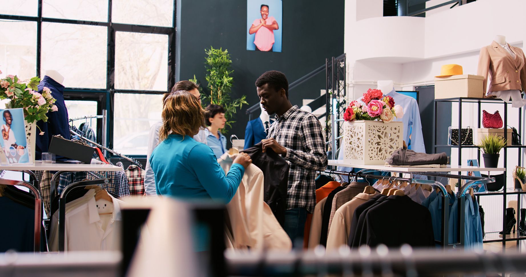 Retail shop owner assisting customers with sales