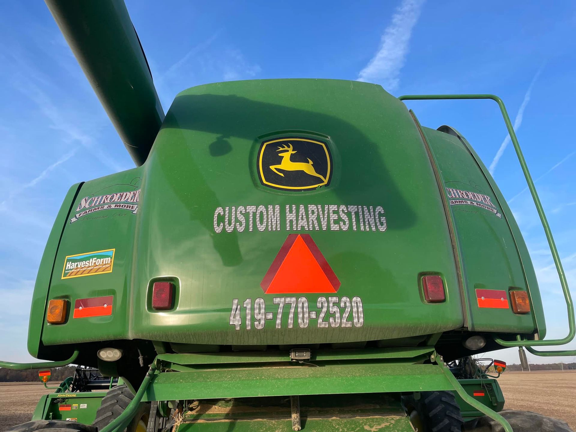 Green John Deere combine with