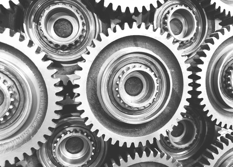 Interlocking metal gears, close-up view, showcasing mechanical precision and interconnectedness.