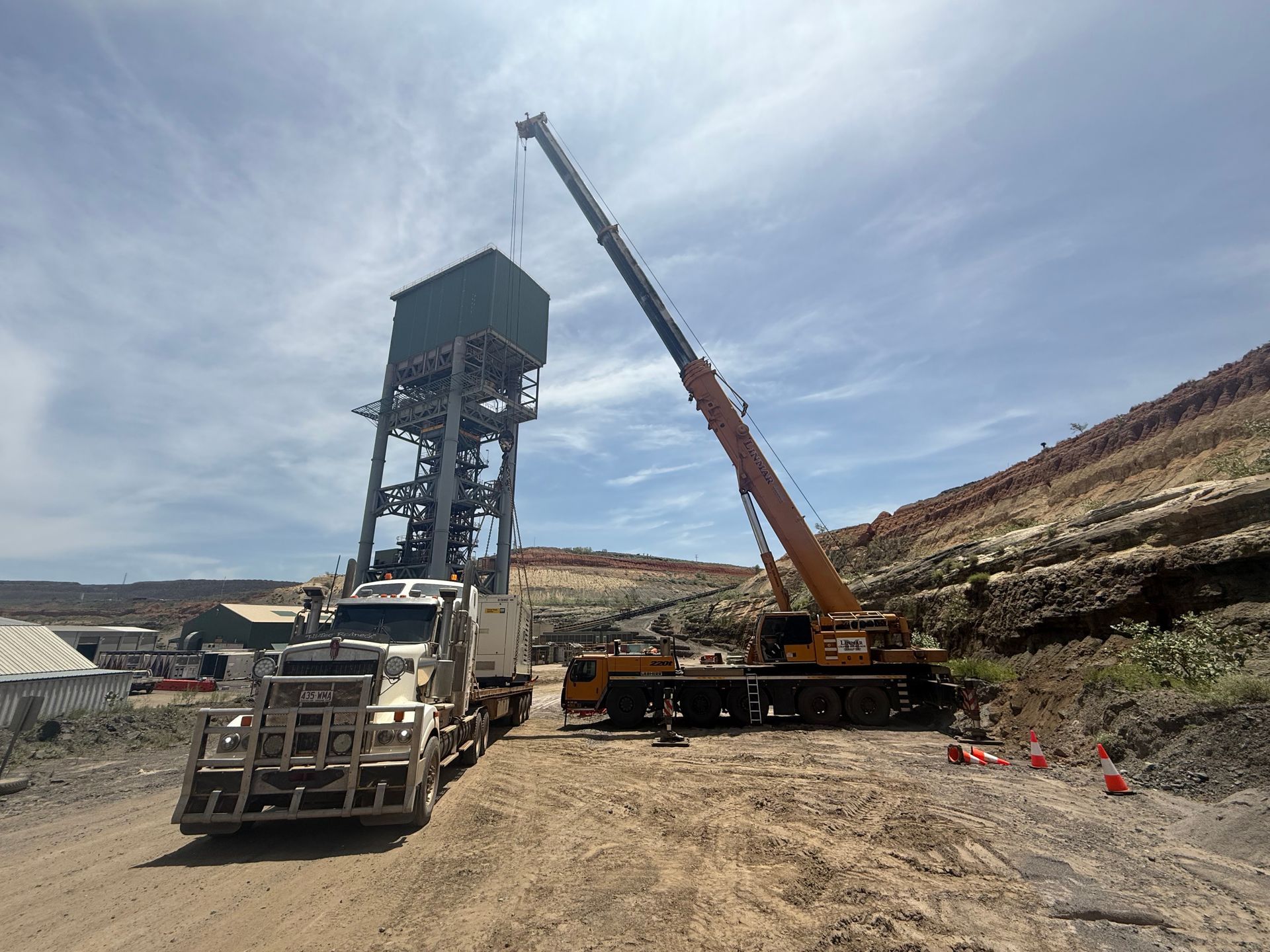 A Crane Lifts a Large Container Onto a Tall Structure — Lincoln Fabrication in Miles End, QLD
