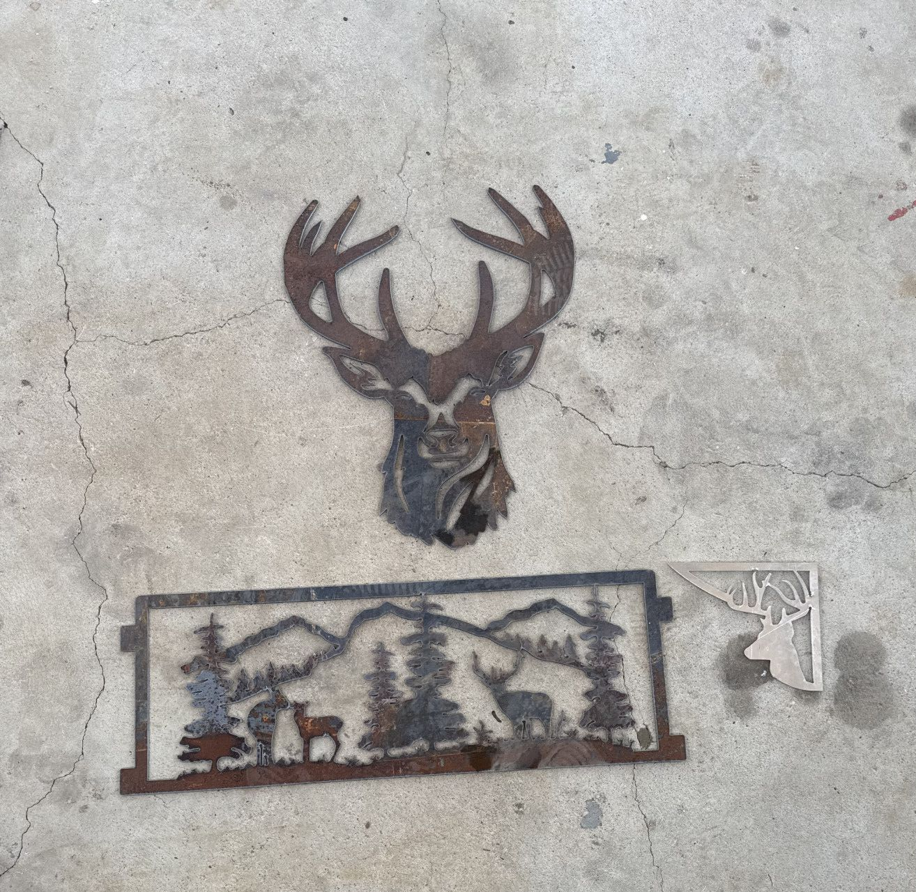 Metal Deer Head and Nature Scene Wall Art Pieces on Concrete — Lincoln Fabrication in Miles End, QLD
